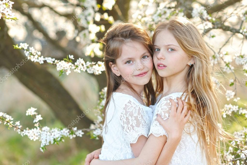 Portrait of two little girls girlfriends spring