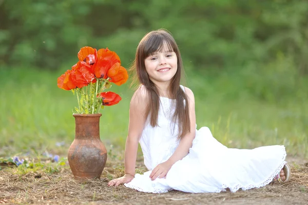 Portrait of a beautiful little girl with poppy — Stock Photo, Image