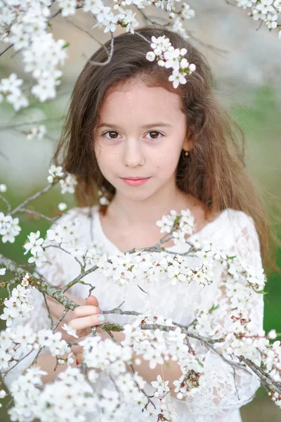 Portrait of a beautiful little girl with flowers — Stock Photo, Image