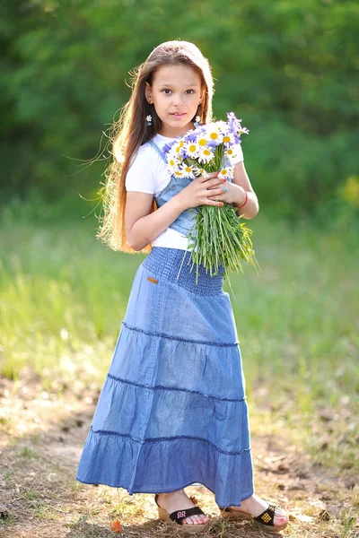 Portrait of a beautiful little girl with flowers — Stock Photo, Image