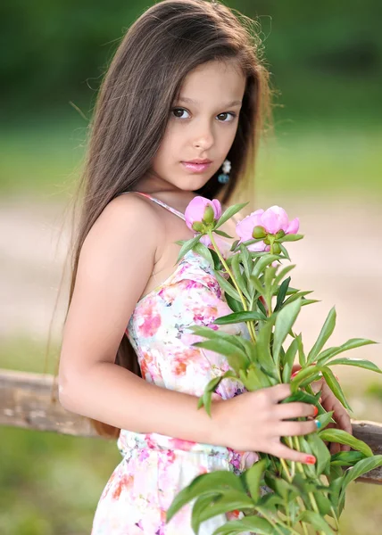 Portrait of a beautiful little girl with flowers — Stock Photo, Image