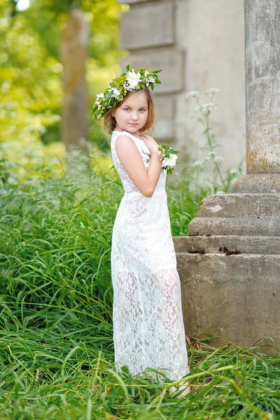 Porträt eines schönen kleinen Mädchens mit Blumen — Stockfoto