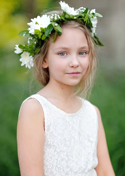 Portrait of a beautiful little girl with flowers — Stock Photo, Image