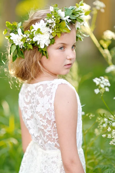 Portrait of a beautiful little girl with flowers — Stock Photo, Image