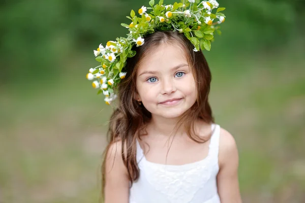 Portrait of a beautiful little girl with flowers — Stock Photo, Image