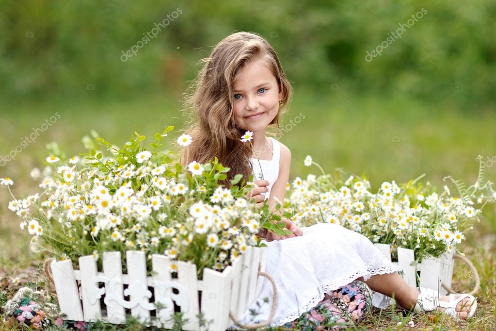 portrait of a beautiful little girl with flowers