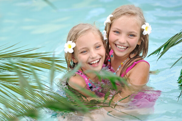 Portrait of two girls in a swimming pool