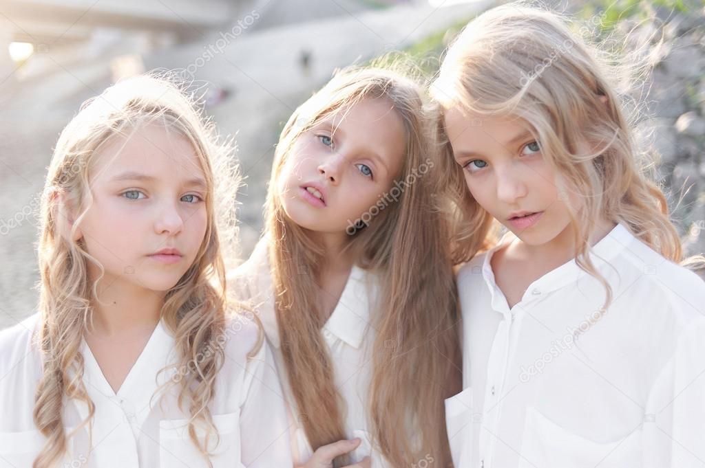 Portrait of three girlfriends on the nature