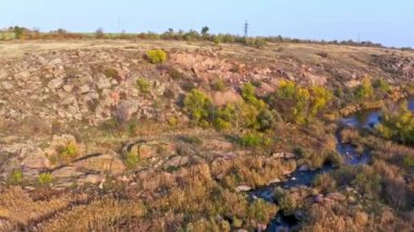 Büyük kayalar arasında pürüzsüz, parlak bir dere akıyor.