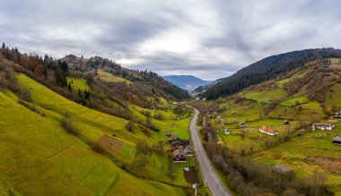 Ukrayna 'da bir sonbahar günü, Karpat Dağları' nın bir dağ vadisinde yol boyunca uzanan küçük bir köy.