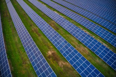 Ukrayna 'daki pitoresk yeşil bir alanda güneş enerjisini kullanmak için devasa bir güneş enerjisi santrali. Hava panoramik İHA görüntüsü