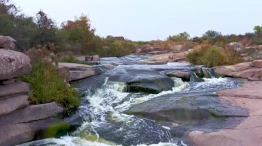 Yumuşak, karanlık ve ıslak taşların arasında hızlı bir dere.
