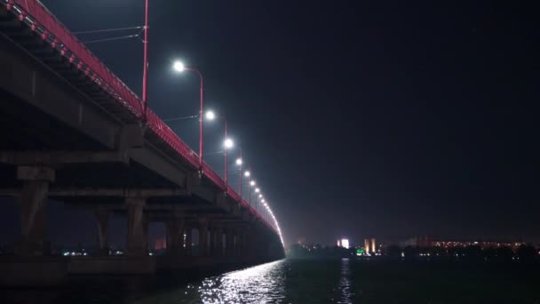 Bottom view of a beautiful bright long bridge over the big beautiful Dnieper river — Stock Video