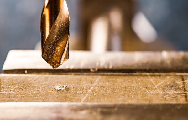 Drill close-up, drilling machine at the workplace of a toolman locksmith