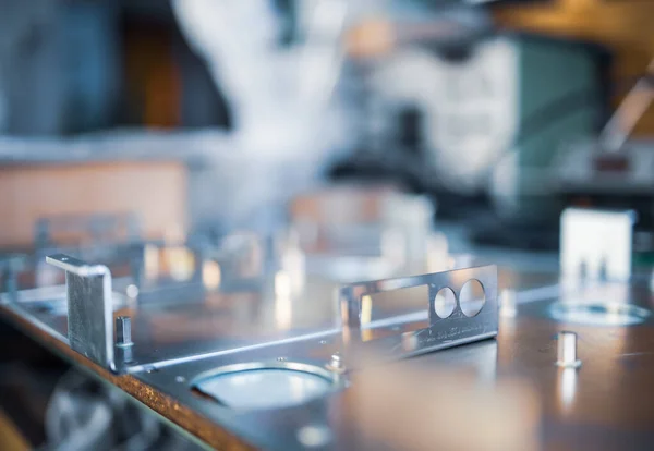 Metal boards and accessories lie on the surface during the production of modern specialized computers and professional medical equipment. Concept of tech production