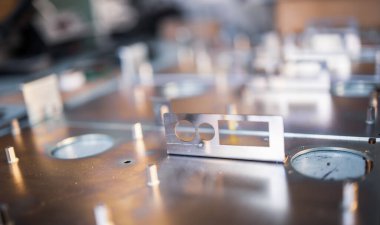 Metal tahtalar ve aksesuarlar modern uzmanlaşmış bilgisayar ve tıbbi ekipman üretimi sırasında yüzeyde yatar. Teknoloji üretimi kavramı