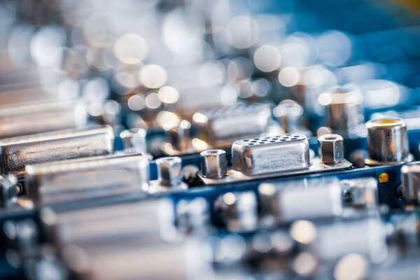 Close-up blurry metal sockets on a computer video board. Concept for the production of computer televisions and audio speakers
