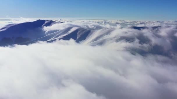 Una straordinaria valle di montagna ricoperta di soffici nuvole al tramonto invernale — Video Stock