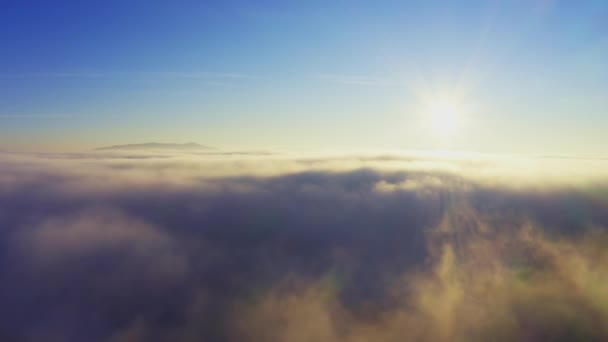 Wonderful view of extraordinary cloudy valley and bright orange sunset — Stock Video