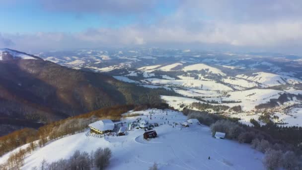 Oud skigebied op een besneeuwde berghelling met veel mensen op ski 's en snowboards — Stockvideo