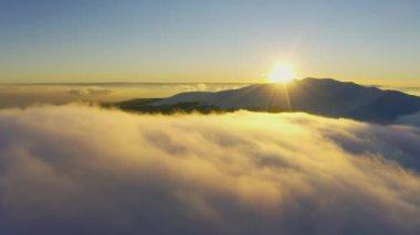 Olağanüstü bulutlu vadi ve parlak turuncu gün batımı manzarası