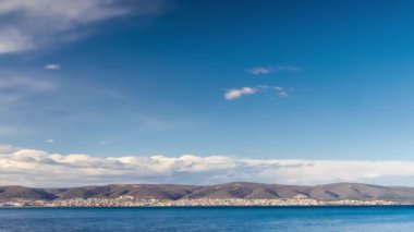 View of magical brilliant bewitching reflection in calm blue quiet Black Sea, against background of sea horizon with cloudy multi-colored sky and bright evening sunset. 4K UHD timelapse video