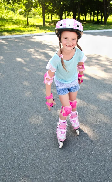 ピンクのローラー スケートでかわいい笑顔女の子 — ストック写真