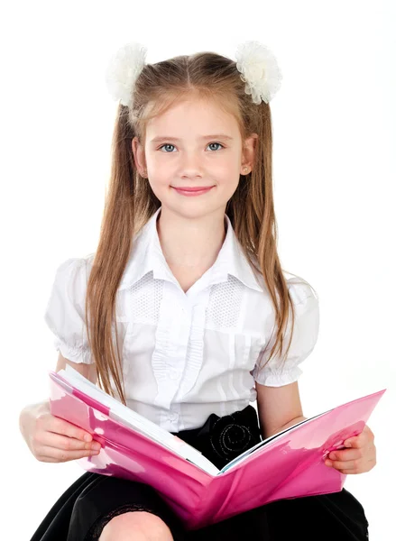 Lachende schattig schoolmeisje met boek geïsoleerd — Stockfoto