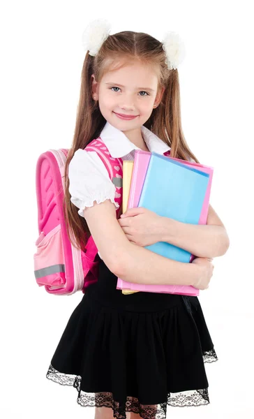 Portret van glimlachen schoolmeisje in uniform met boeken geïsoleerd — Stockfoto