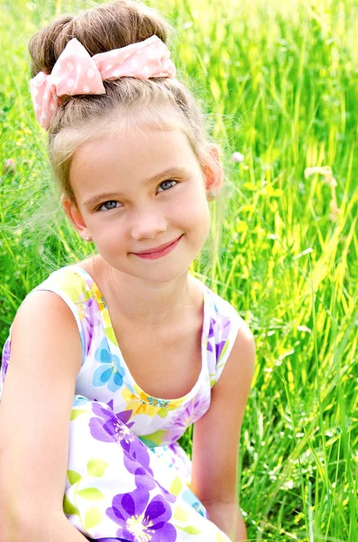 Adorable smiling little girl on the meadow in summer day — Stock Photo, Image