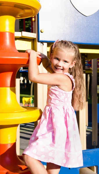 Little girl is climbing up on ladder in playground equipment — Stock Photo, Image