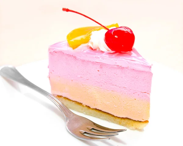 Piece of cream cake with cherry on plate and fork — Stock Photo, Image