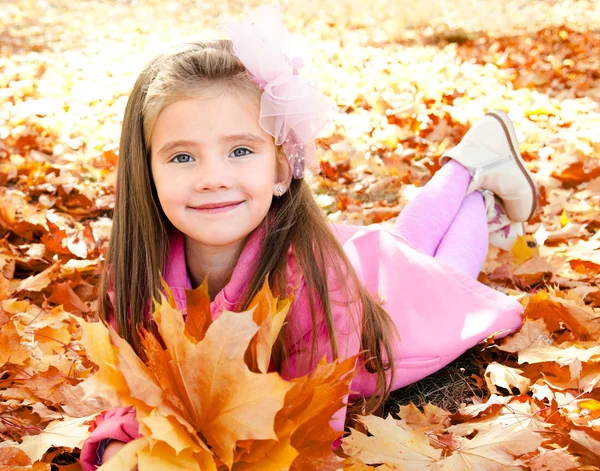 Autumn portrait of cute smiling little girl with maple leaves — Stock Photo, Image