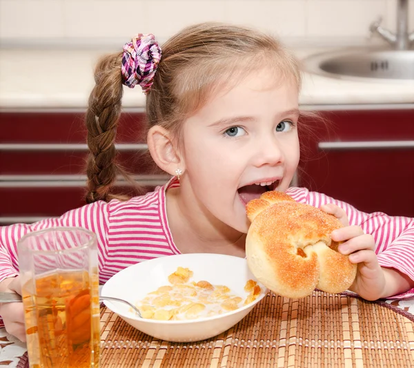 Cute smiling little girl having breakfast cereals — Stock Photo, Image