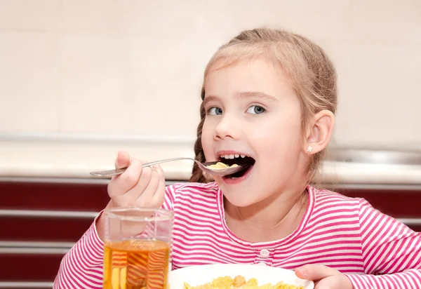 Cute little girl having breakfast cereals with milk — Stock Photo, Image