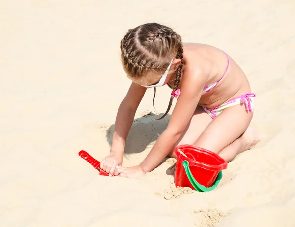 Bonito sorrindo menina brincando na praia — Fotografia de Stock