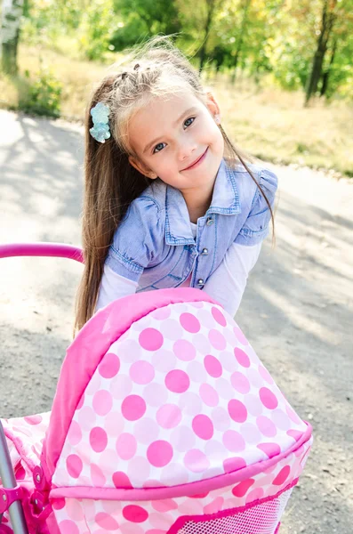 Söt leende liten flicka leker med hennes leksak transport — Stockfoto