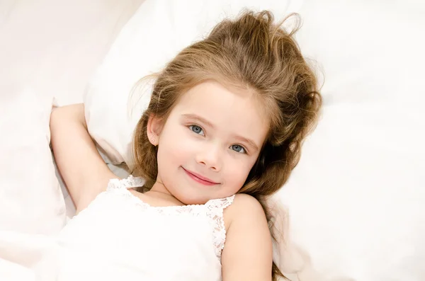 Adorable smiling little girl waked up — Stock Photo, Image