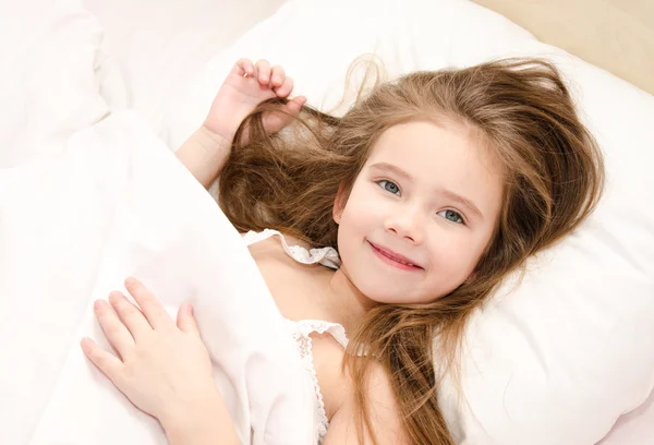 Adorable smiling little girl waked up — Stock Photo, Image