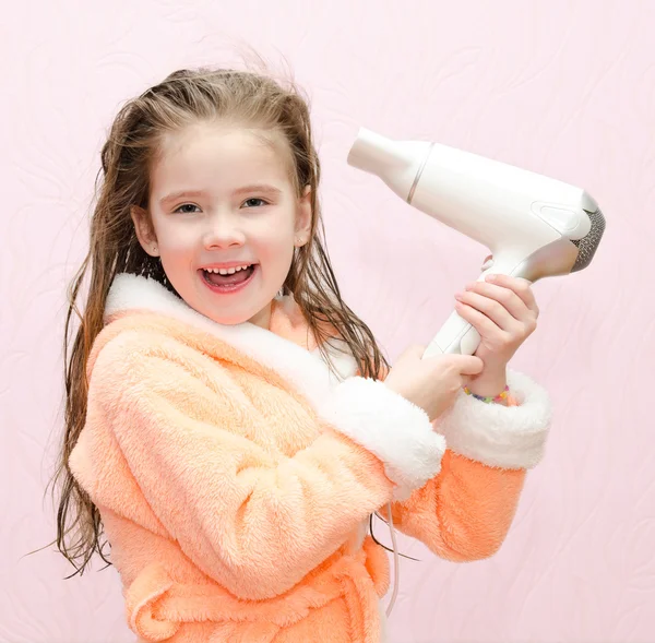 Cute smiling little girl dries hair — Stock Photo, Image