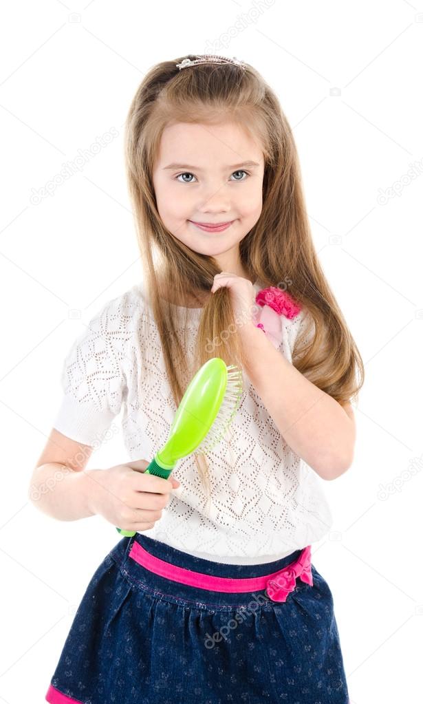Cute smiling little girl brushing her hair isolated