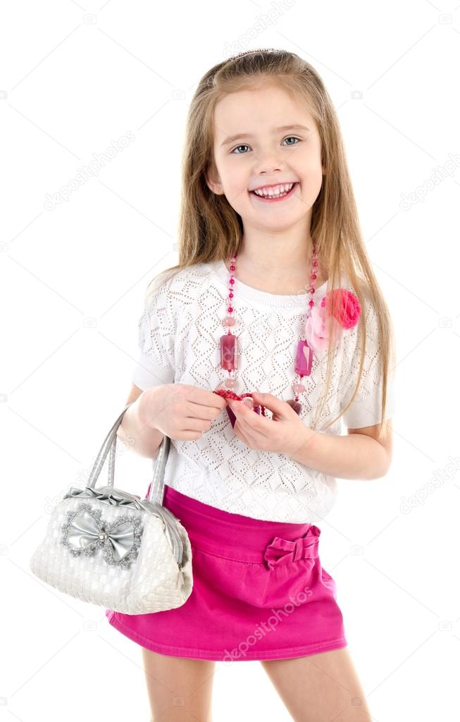 Cute smiling little girl in skirt wiht bag and beads