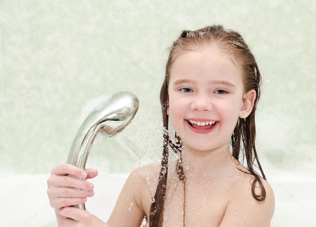 Happy little girl closeup taking shower
