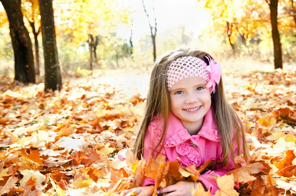 Autumn portrait of happy little girl with maple leaves — Stock Photo, Image