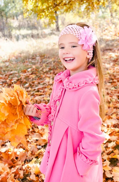 Autumn portrait of adorable little girl with maple leaves — Stock Photo, Image