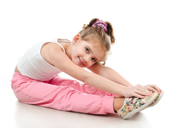Χαριτωμένο μικρό κορίτσι κάνει γυμναστική άσκηση — Φωτογραφία Αρχείου