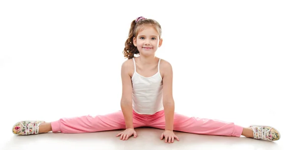Милая маленькая девочка делает гимнастические упражнения — стоковое фото
