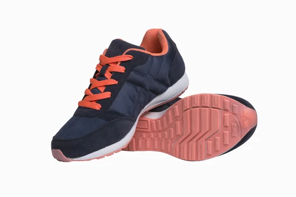 Mörk blå sneakers med orange skosnören — Stockfoto