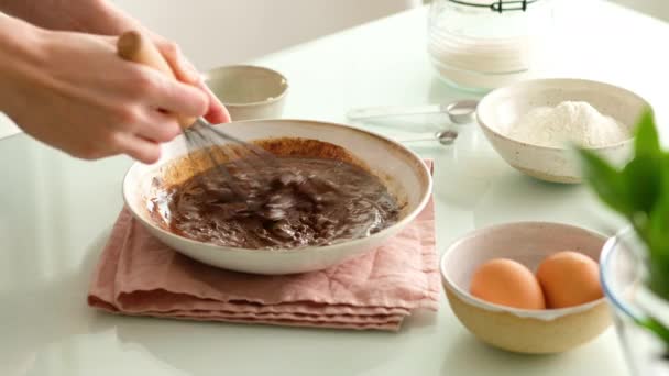 Свежеиспеченные шоколадные печенья. Женские руки готовят тесто для шоколадного печенья на стеклянном столе. Крупный план. — стоковое видео