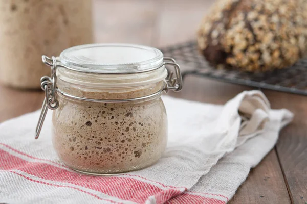 Active rye sourdough starter in a jar. Copy space.